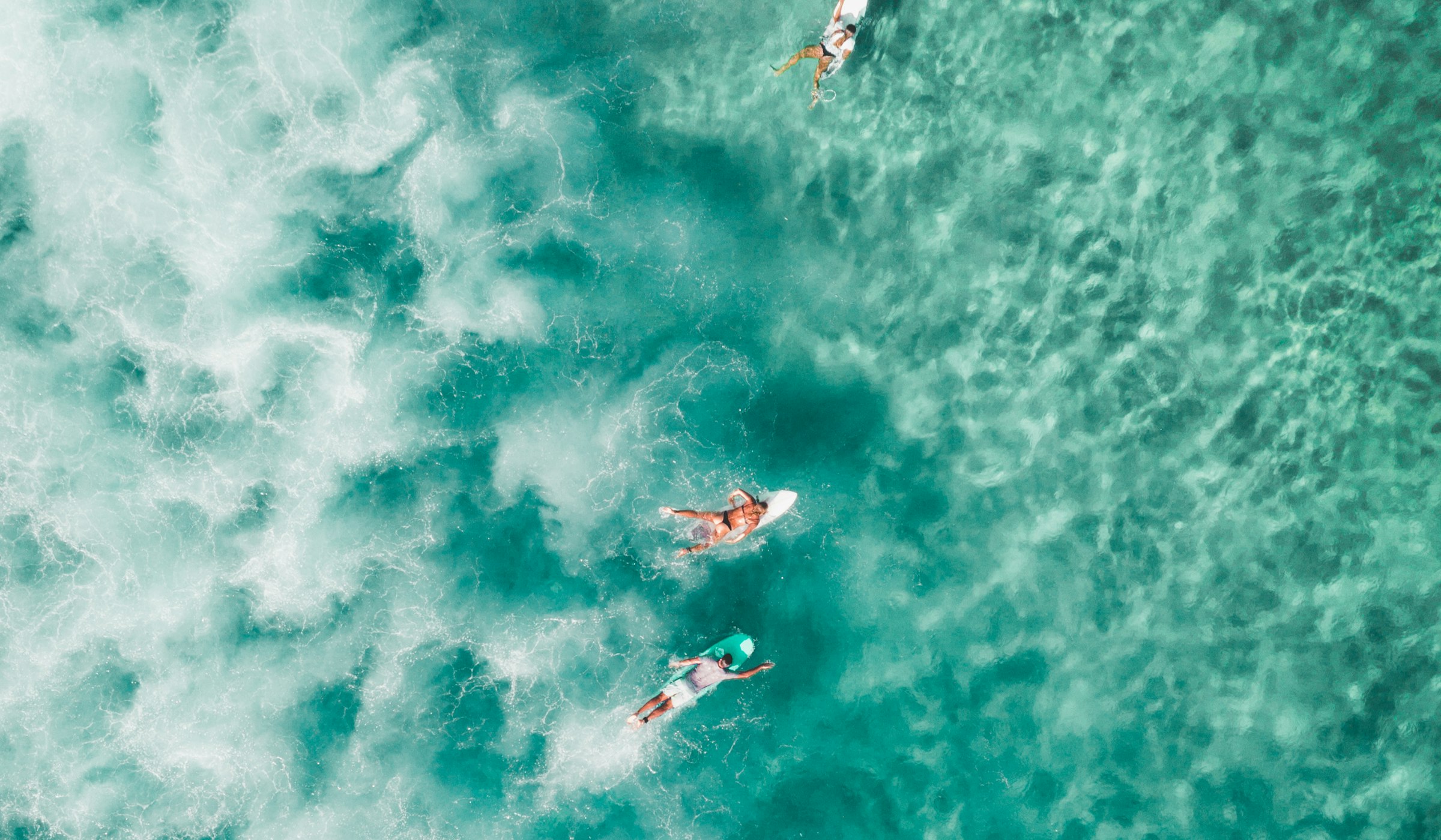 Aerial drone view of surfers waiting in the lineup